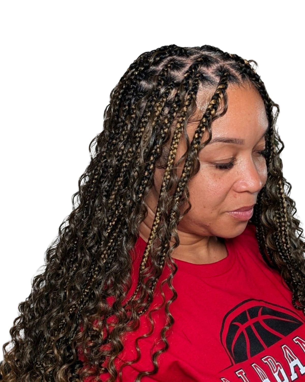 Client wearing boho knotless braids with loose curls