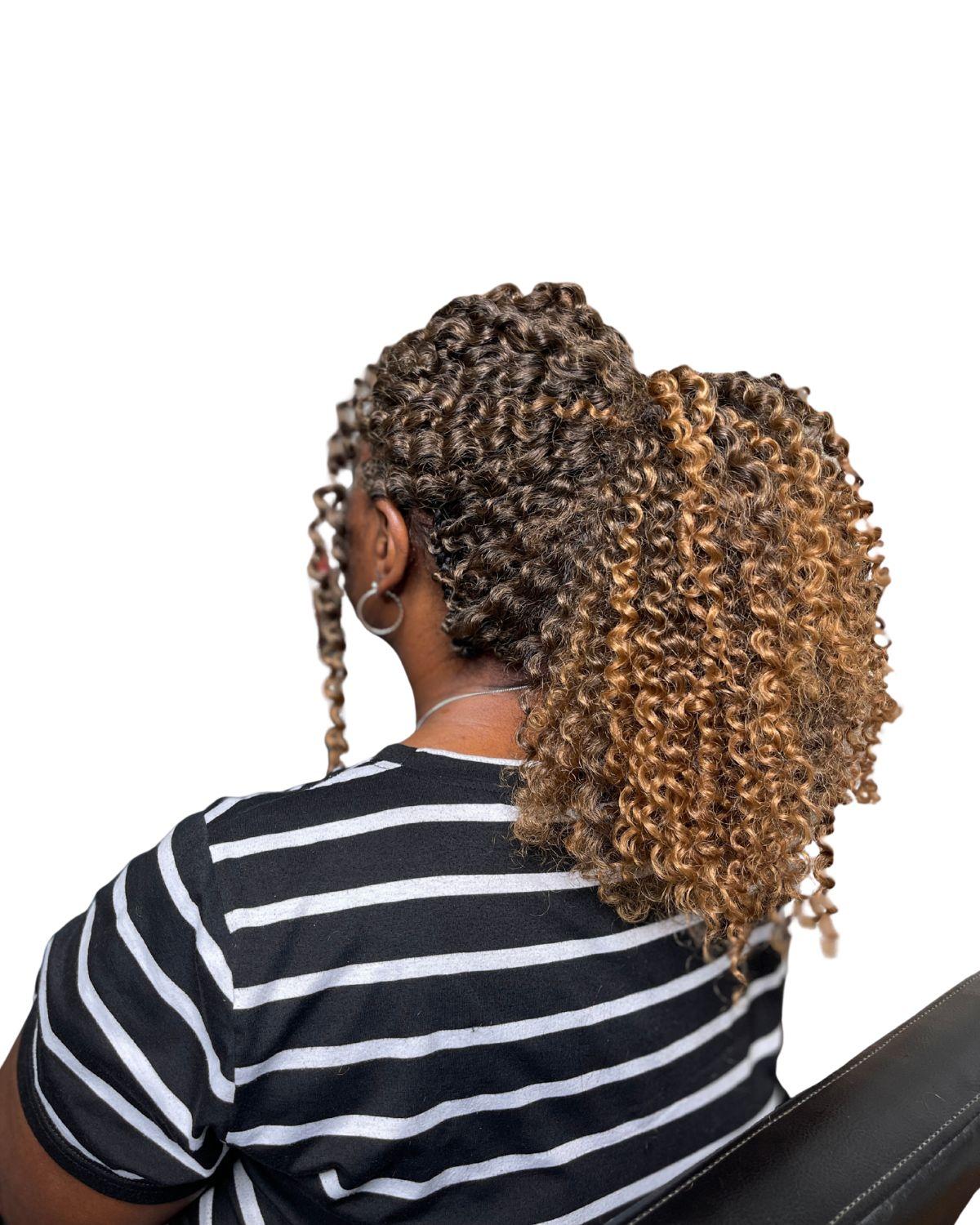 Client wearing a professionally installed crochet hairstyle